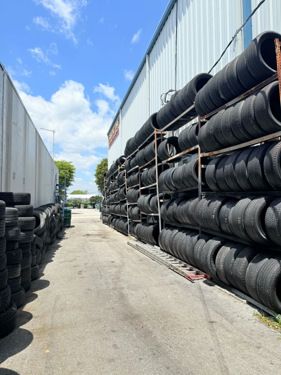 Stacks of tires along industrial building