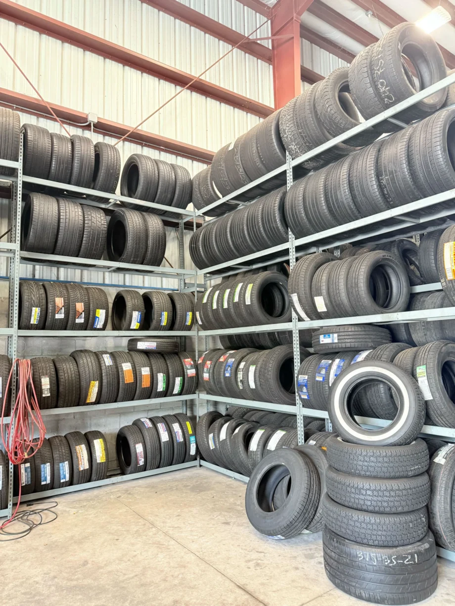 Tires stacked on metal racks in warehouse